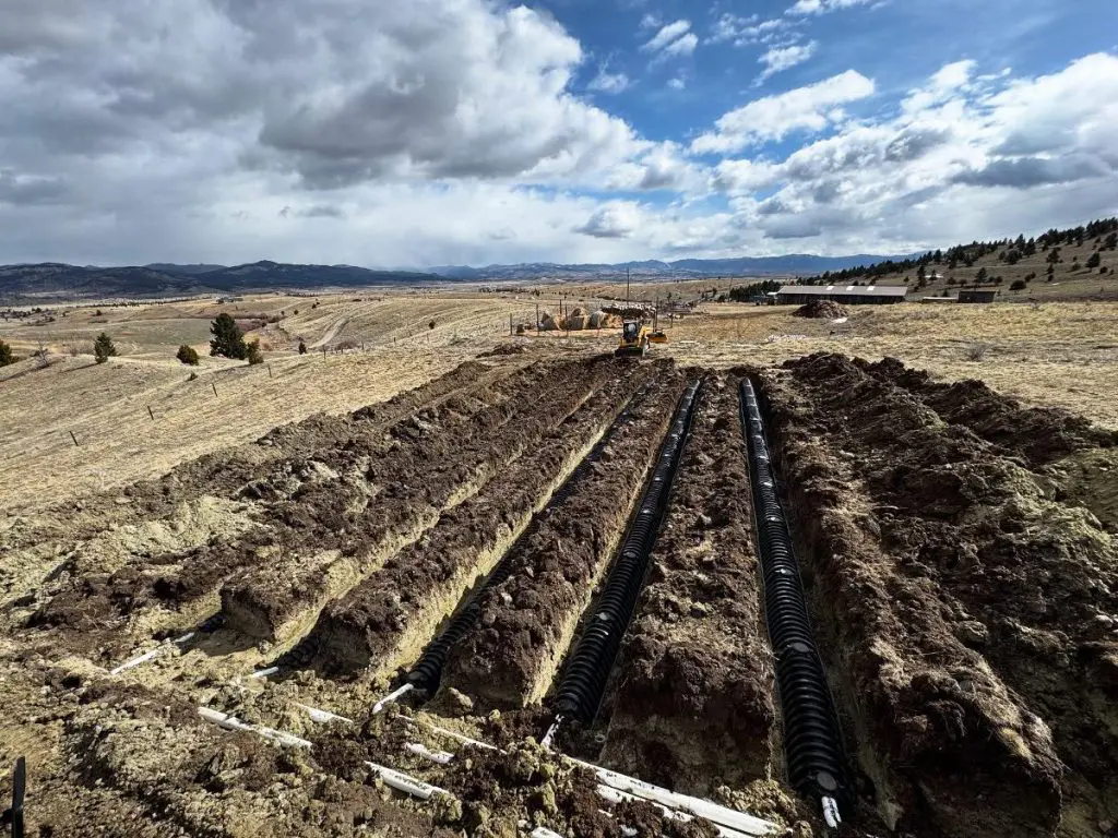 Schaefer Excavating crew installing a septic system at a residential property in Helena, MT
