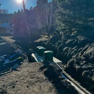 Excavator digging a trench for a septic system