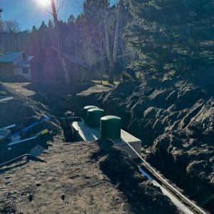 Excavator digging a trench for a septic system