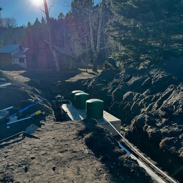Excavator digging a trench for a septic system