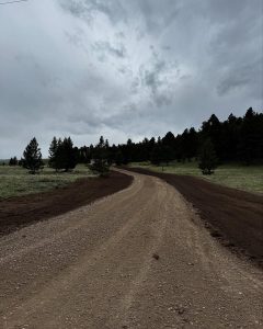 Road grading in progress by Schaefer Excavating in Helena, MT using heavy equipment