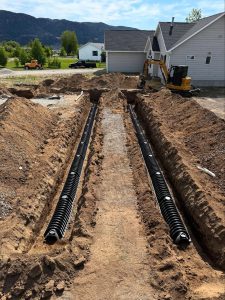 Septic tank installation site by Schaefer Excavating in Helena, MT, featuring trench lines and tank placement