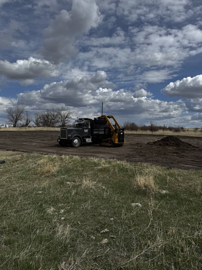 Dozer and dump truck preparing construction site in Montana