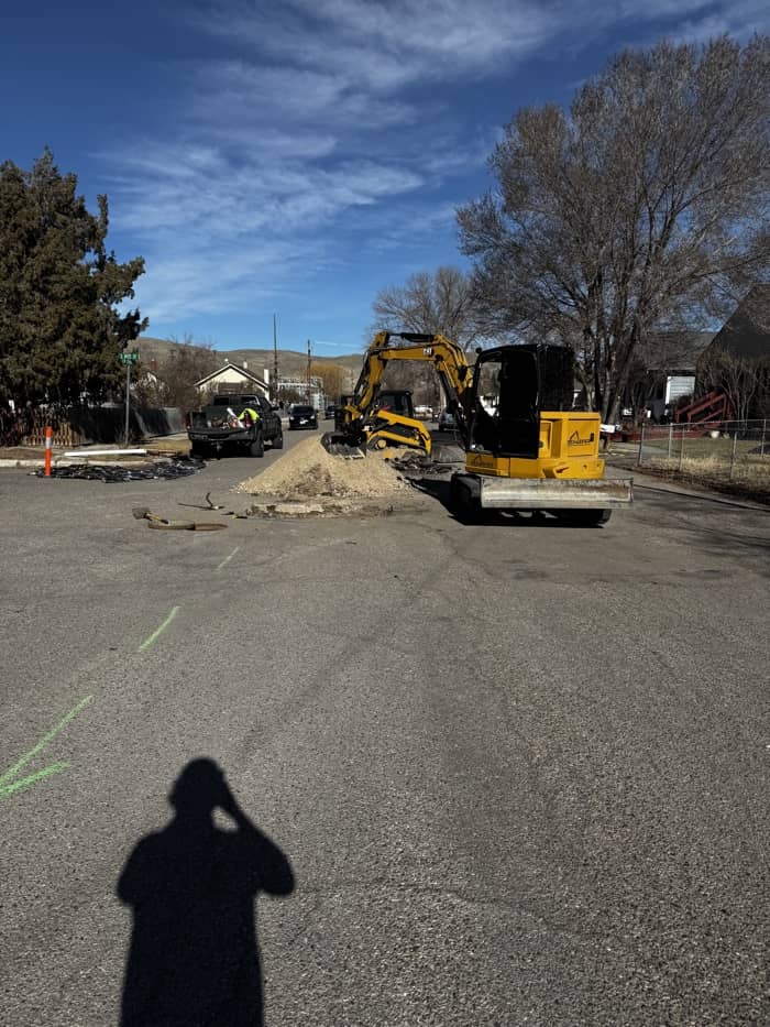 Schaefer Excavation crew digging up city street for underground service repair in Montana