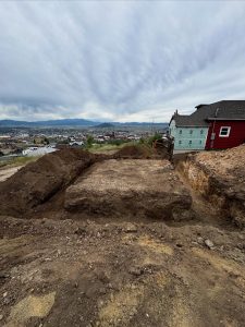 Excavator digging a trench for a septic system