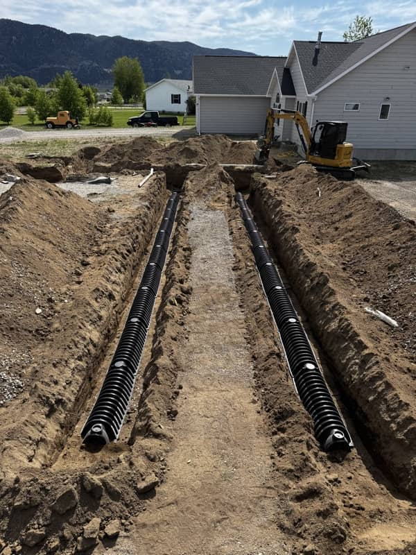 Excavator grading a construction site in Butte, Montana