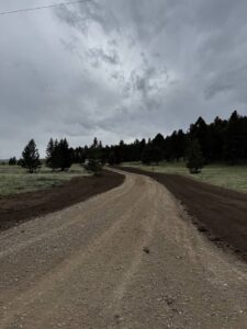 Road building Butte MT by Schaefer Excavating showing newly graded gravel access road in Southwest Montana